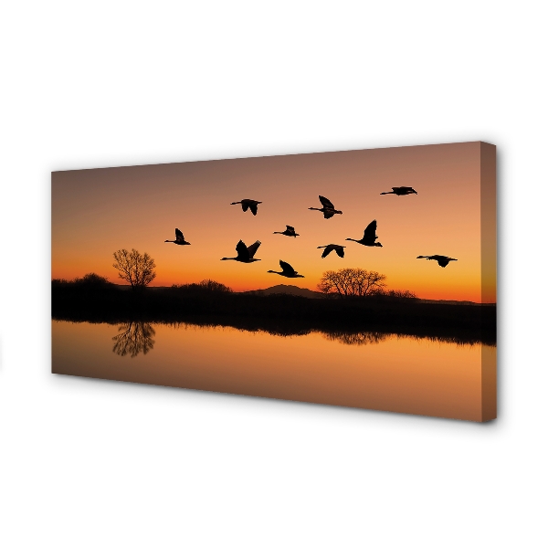 Slika na platnu Ptice koje lete na zalasku sunca