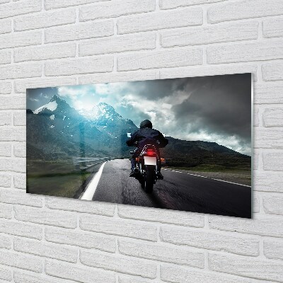 Fotografija na staklu Motocikl planina cesta čovjek nebo
