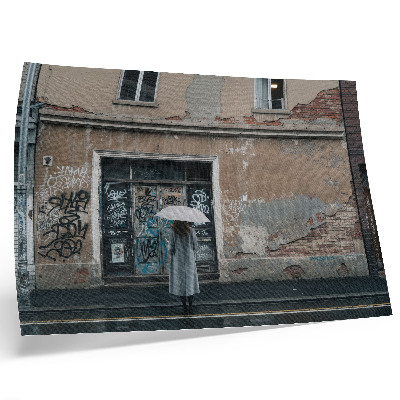 Umjetnički print Osoba s kišobranom ispred zida punog grafita